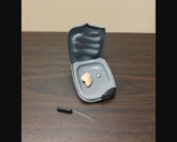 Hearing Aid in a Case With a Battery and Cleaning Tool